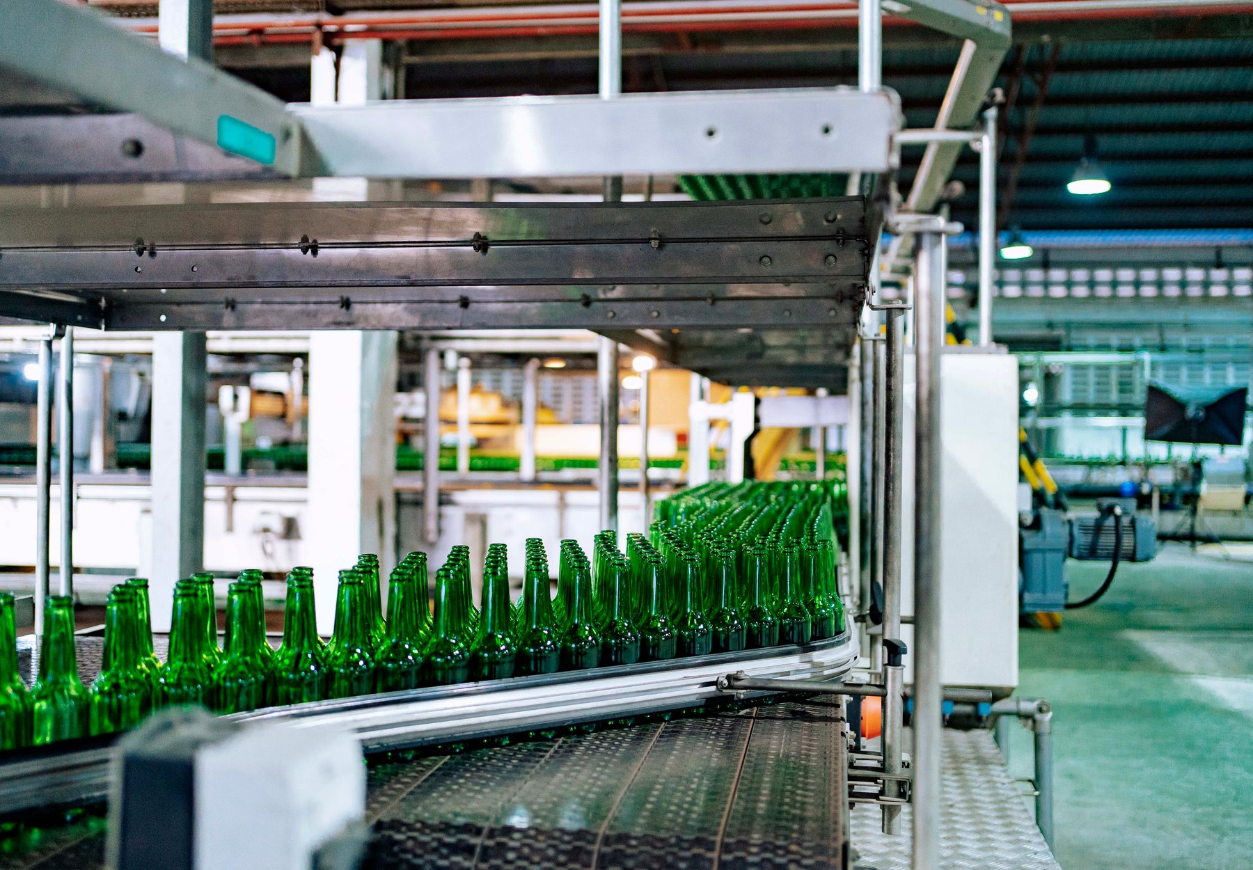 Green bottle production line showing automated packaging flow